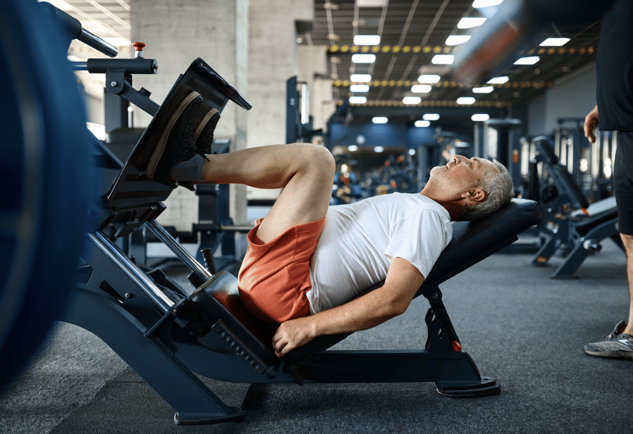 Older man doing leg press exercise in the gym